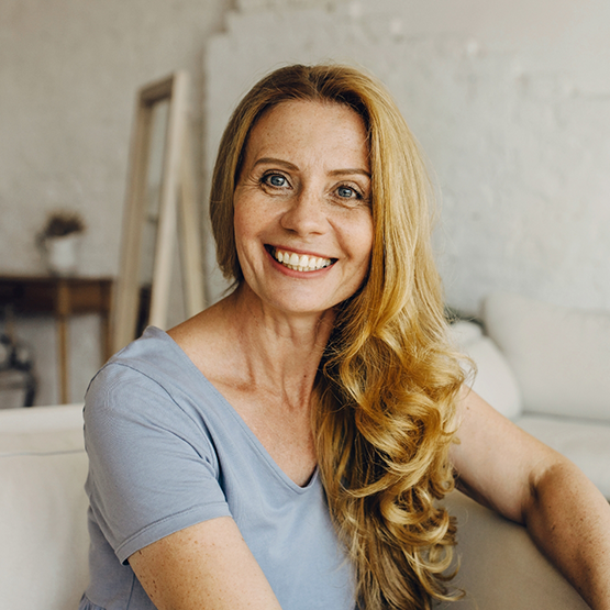 Smiling woman with long curly hair