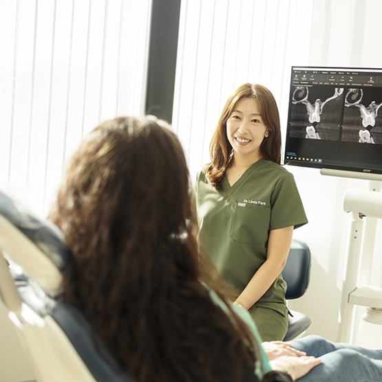 Periodontist talking with a patient
