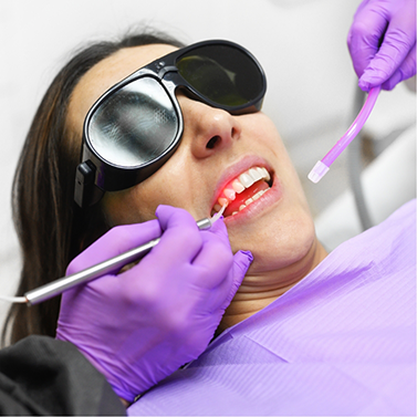 Woman receiving laser gum disease treatment
