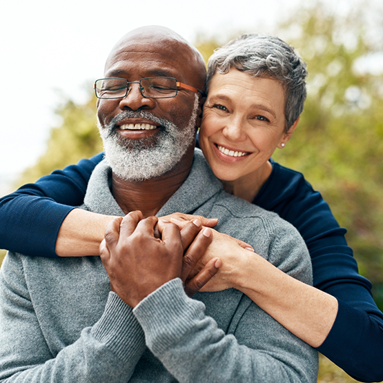 Older couple smiling and embracing